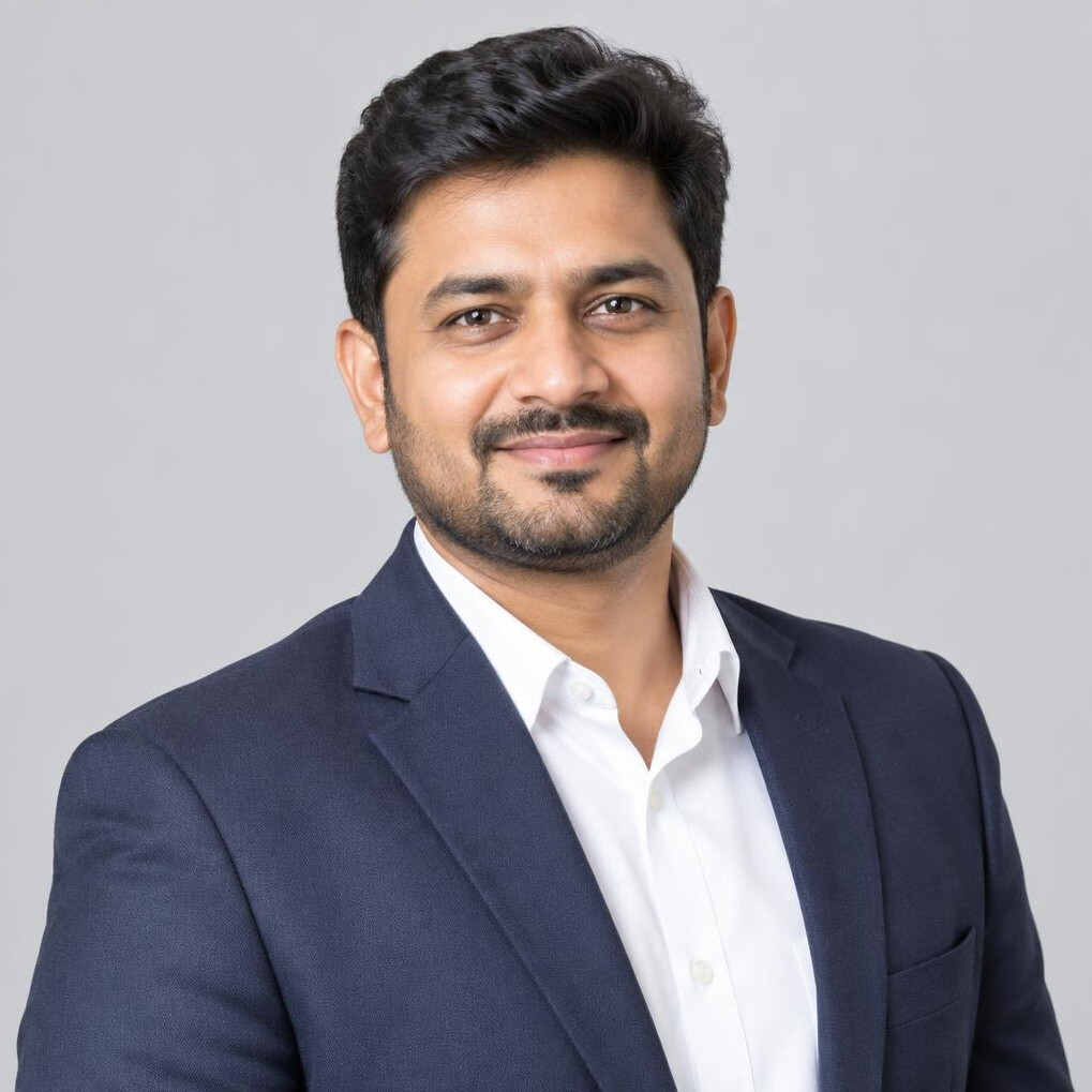Studio portrait of a smiling South Asian businessman in his 30s